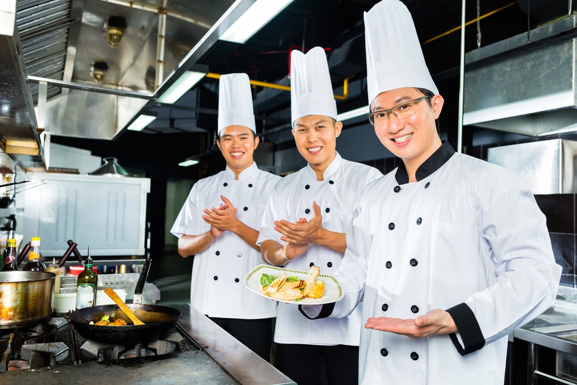 Asian Chefs in Hotel Restaurant Kitchen