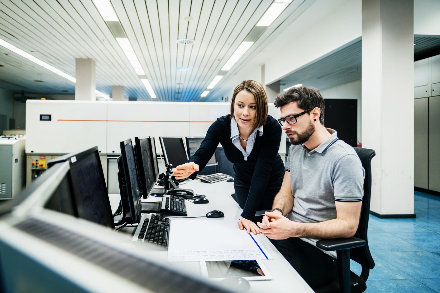 Operations Manager Working With Engineer At Computer